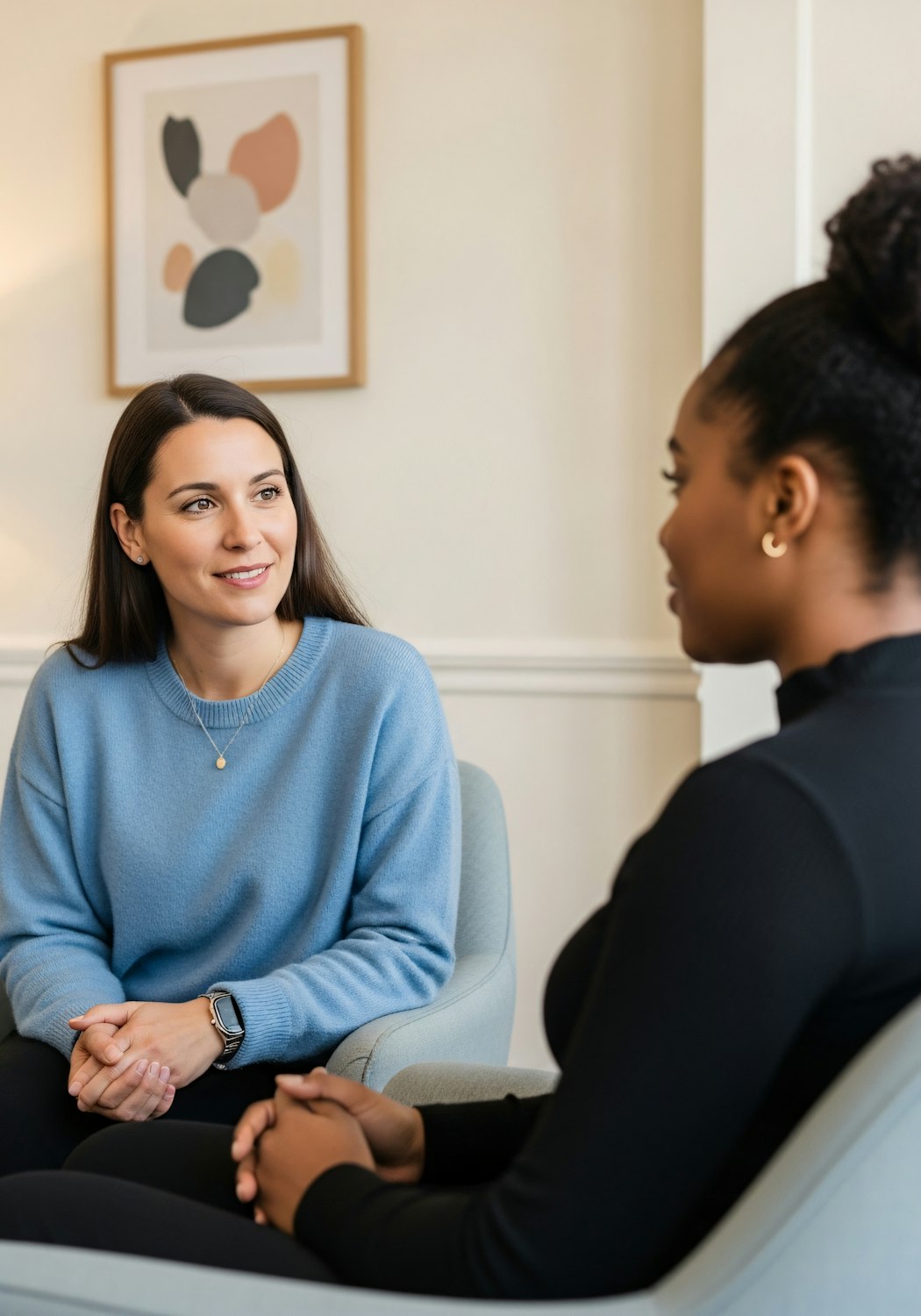 A person engaging in a calm and confidential conversation with a therapist, illustrating the safe space therapy provides for addressing anxious thoughts.