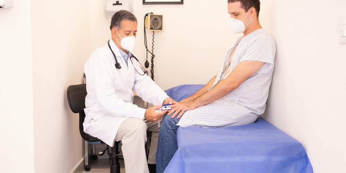 A patient and a doctor engaged in a private, supportive conversation during a consultation.