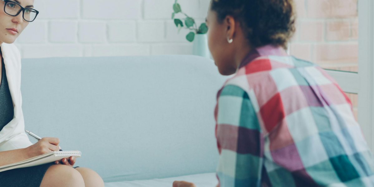 A psychologist guides individuals through talk therapy, helping them develop coping mechanisms and reframe thought patterns.