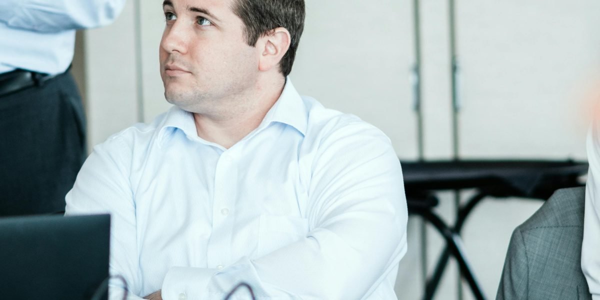 A person experiencing visible signs of nervousness and anxiety before giving a significant presentation.