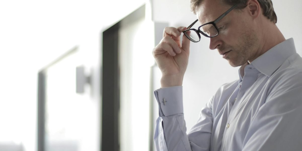 A person in quiet thought, reflecting on the decision to seek professional help for their mental health.
