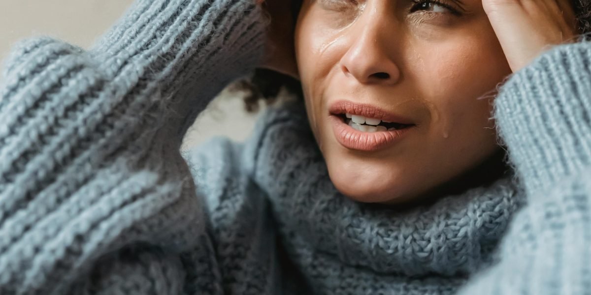 A person experiencing visible signs of anxiety, reflecting the common struggles many individuals face.