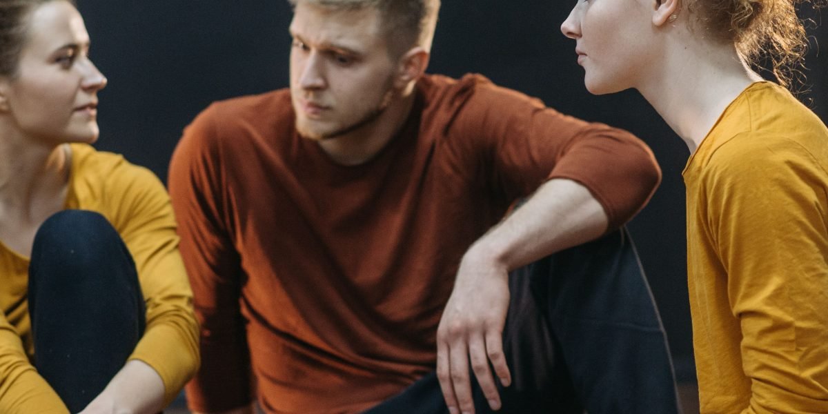 Individuals openly sharing and listening in a supportive group setting, embodying the essence of peer support.