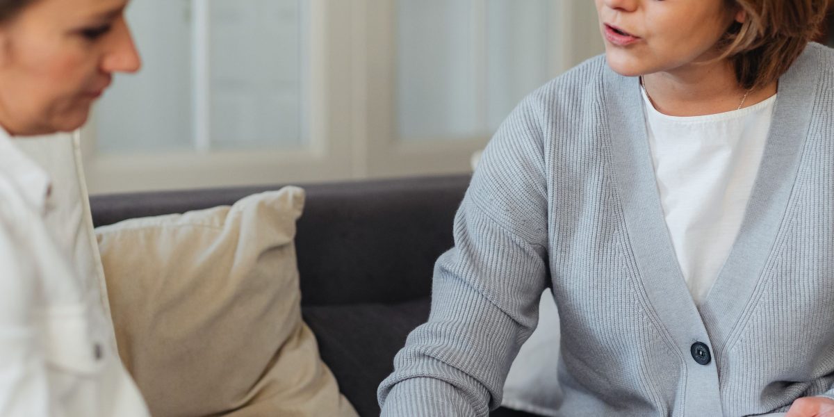 A client openly sharing their experiences and feelings with a therapist in a supportive session.