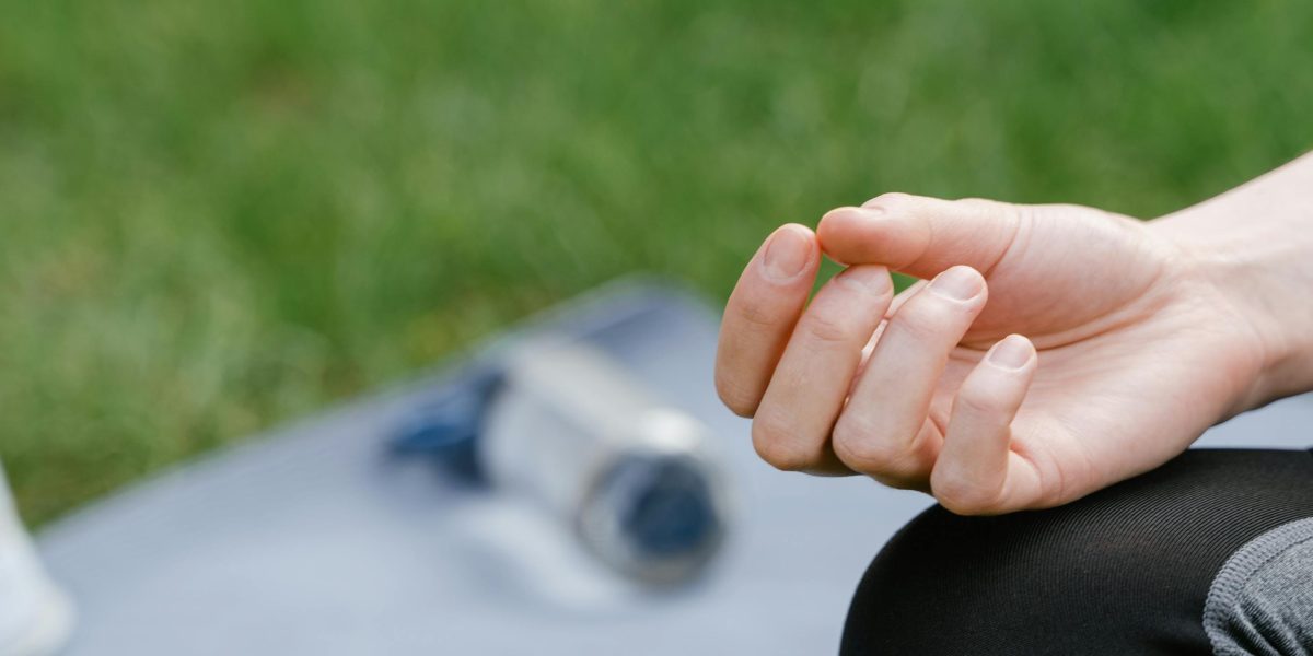 An individual finding calm and focus through mindfulness meditation in a serene setting.
