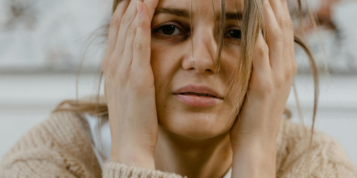 A person reflecting on their feelings, symbolizing the first step towards seeking therapy.