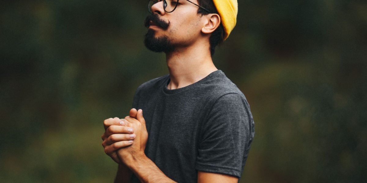 A person finding a moment of peace in nature, reflecting on gentle ways to manage stress and anxiety.