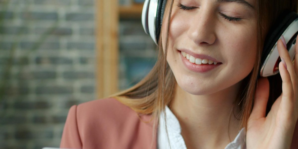 A person thoughtfully selecting songs for a personalized anti-anxiety playlist.