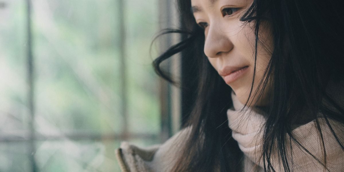 A person in deep thought, demonstrating reflection and challenging internal narratives.