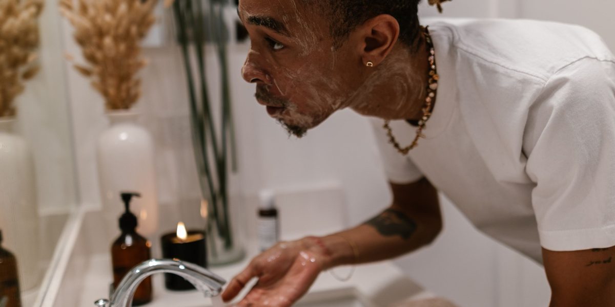 A person splashing cold water on their face, using a sensory quick-shift for immediate calm.