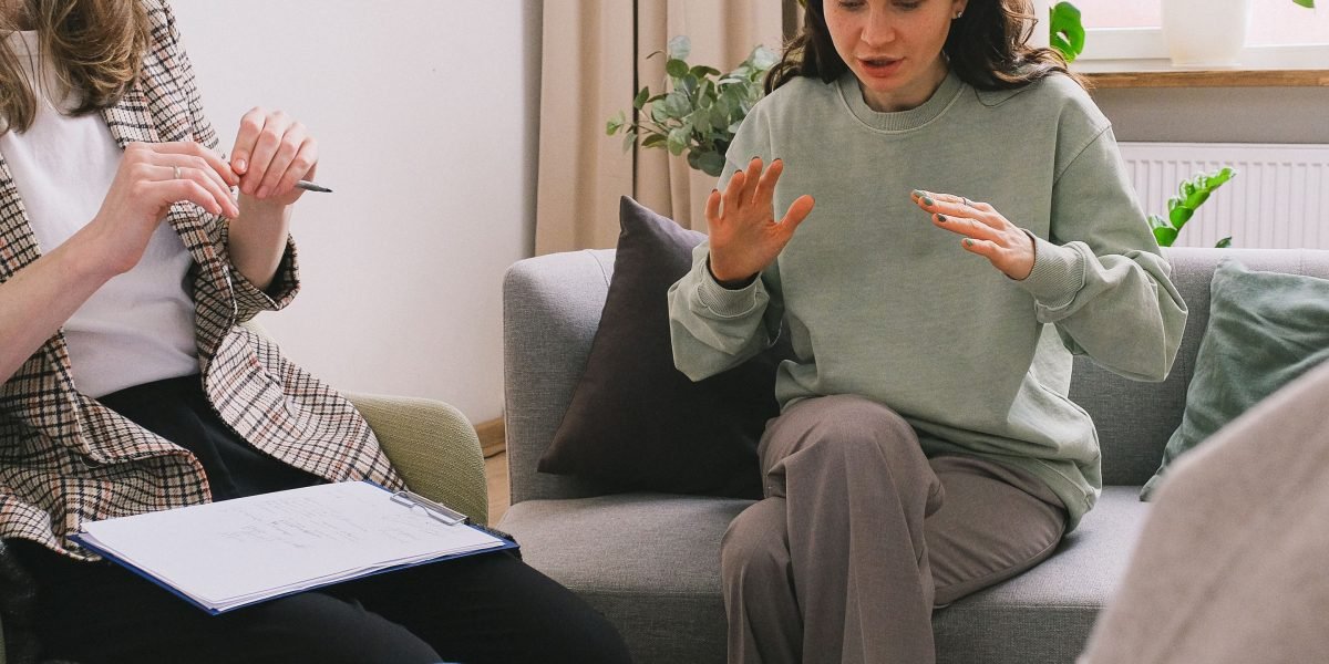 Individuals in a group setting, sharing experiences and offering support, highlighting the communal aspect of recovery.