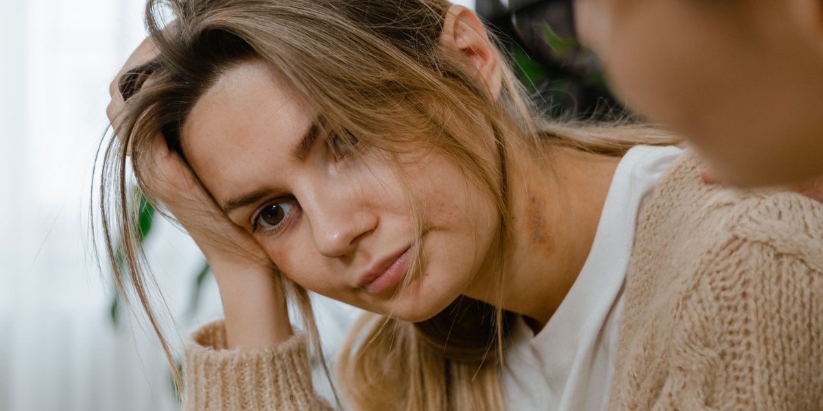 A person looking thoughtful, contemplating the decision to seek professional help for their mental well-being.