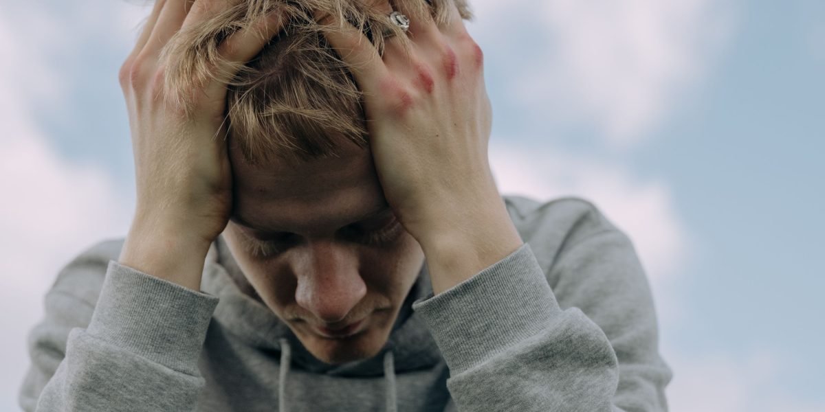 A person experiencing confusion or overwhelm, reflecting the common struggle of choosing a mental health professional.