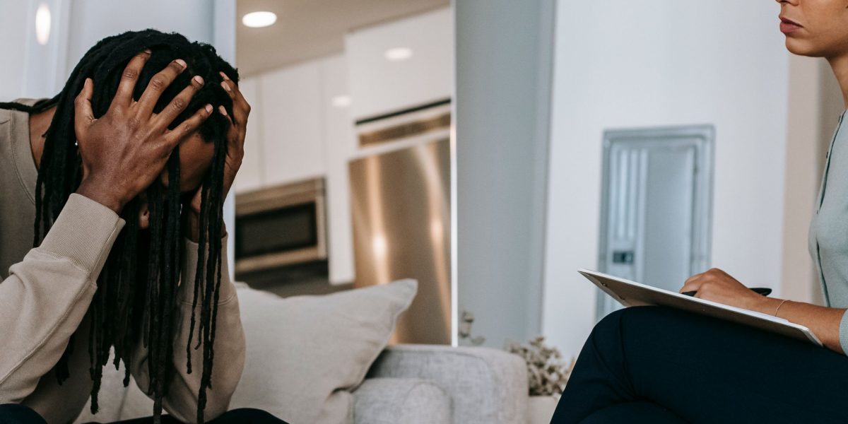 A therapist actively listening to a patient during an individual counseling session, symbolizing support and communication.