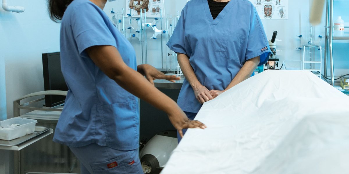 A group of professionals, possibly including family, collaboratively reviewing documents for a patient's discharge plan.