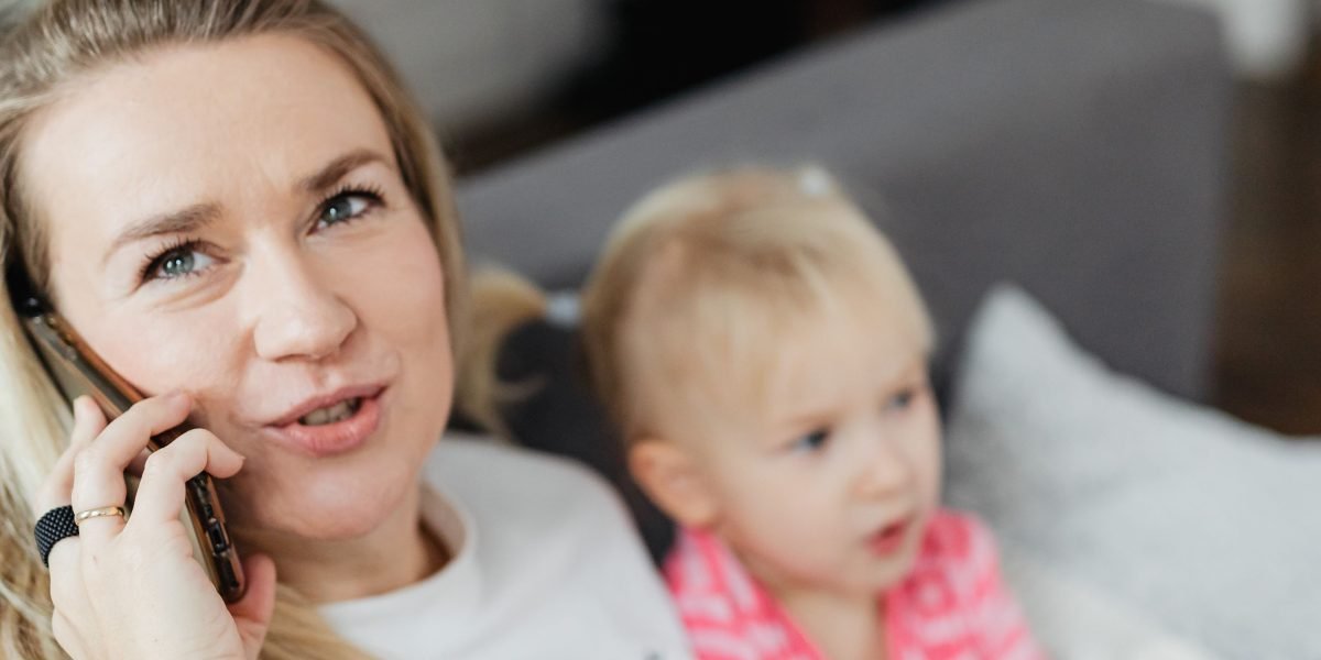 A parent engaged in a phone consultation, seeking the right professional help for their child.