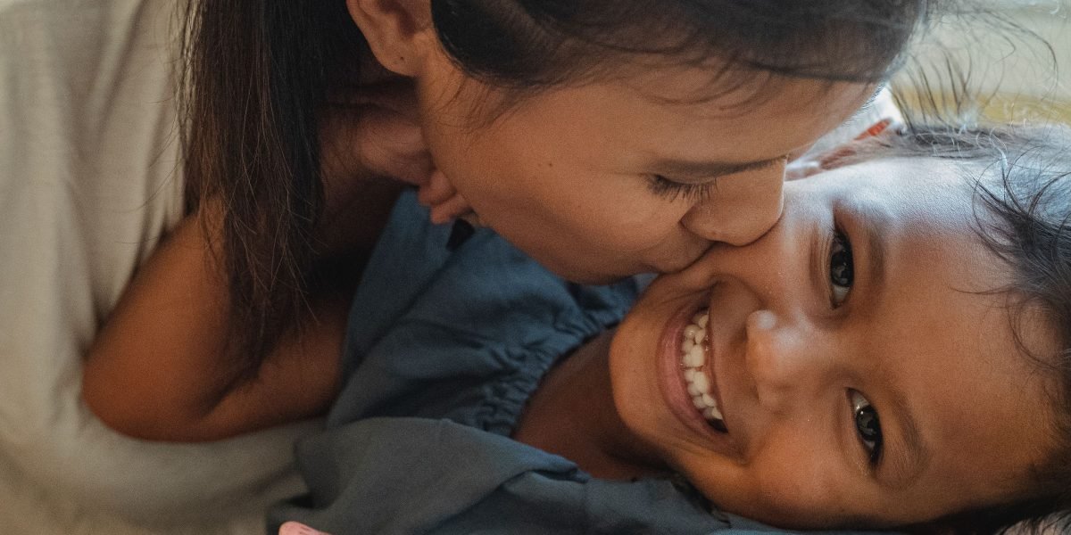 A child and parent sharing a joyful moment, reflecting the positive impact of support.