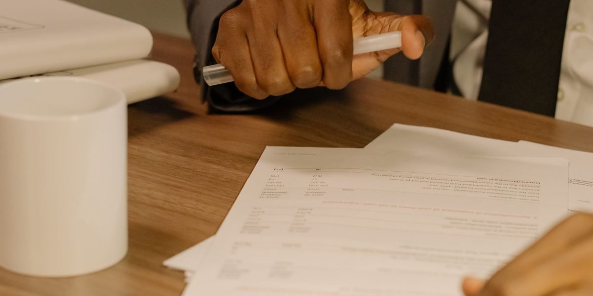 An individual thoughtfully reviews documents, symbolizing the important decision of choosing a therapist.