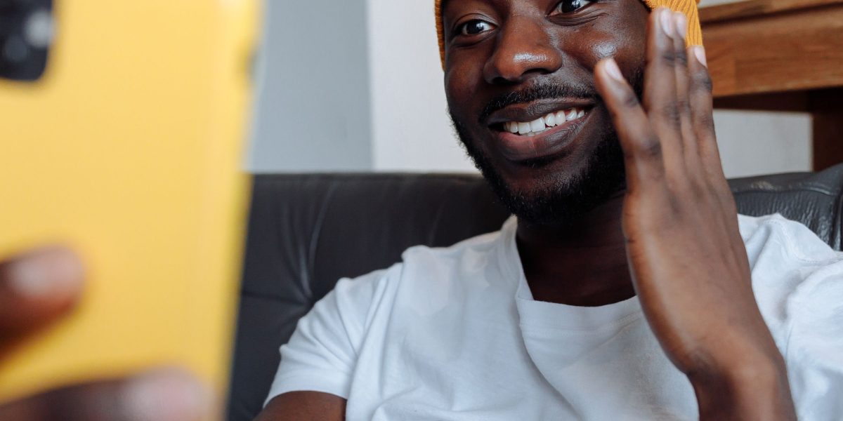 A person engages in a video call from home, representing the convenience of teletherapy options.