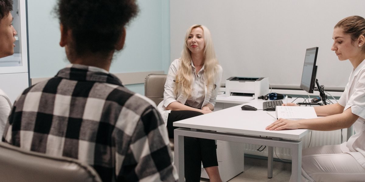 Medical professionals collaboratively discussing a patient's treatment, highlighting the importance of coordinated care.