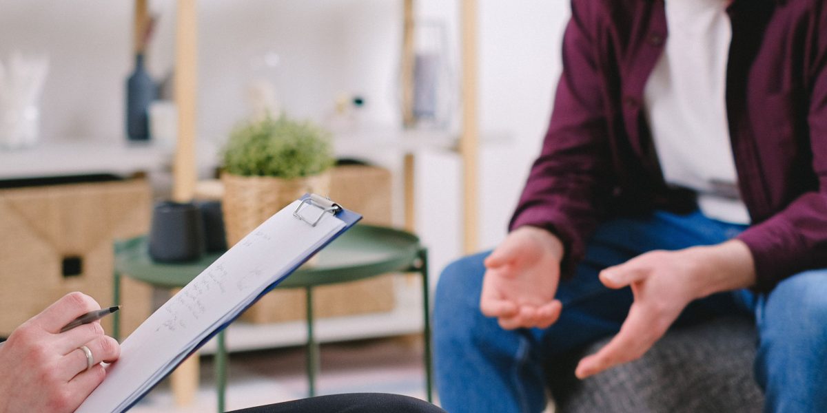 A person in a supportive conversation with a professional, exploring mental health strategies.