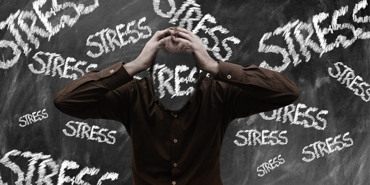 A person appears overwhelmed, illustrating the common experience of stress impacting daily life and body functions.