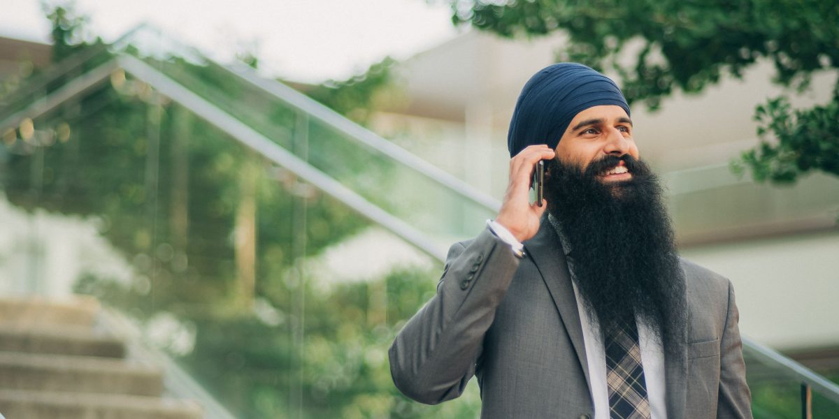 A person on the phone, actively communicating to gather information about their healthcare plan.