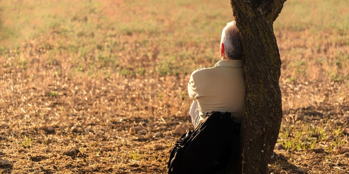 A person in a serene setting, contemplating their mental health journey and the path to well-being.