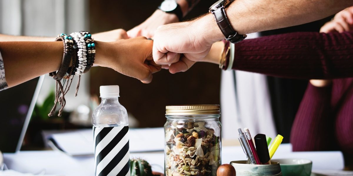 A diverse group of individuals engaging in a peer support meeting, sharing experiences and offering mutual encouragement.